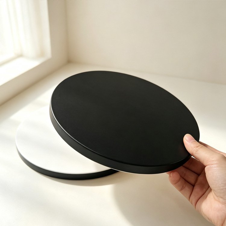 Custom 12 Inch Black Cake Drum Round Hand holding black cake drum – 12 inch round board showing thickness and quality